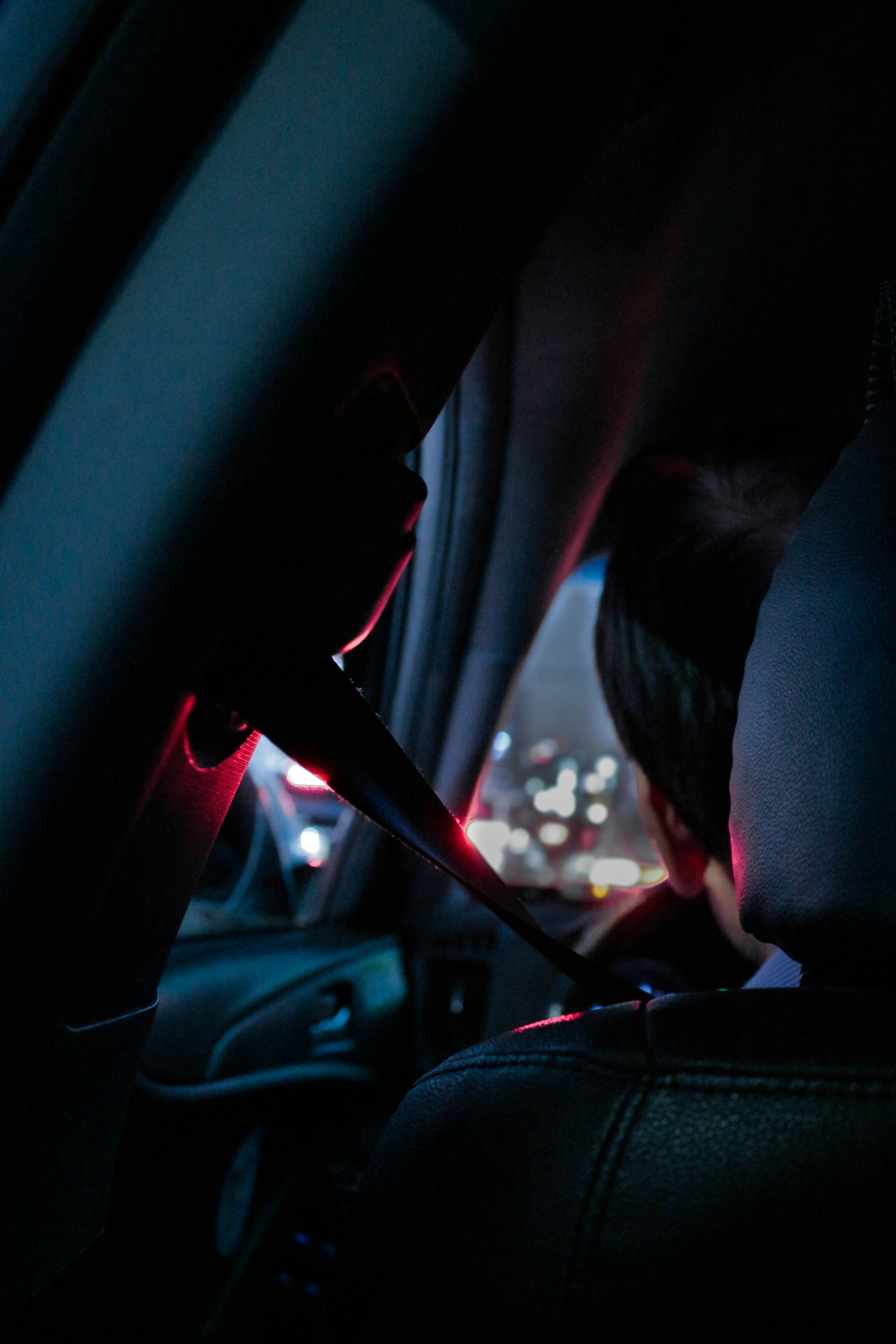 man sitting on drivers seat close-up photography